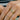 A collection of gold rings worn on a person's fingers, including a simple band, a stack of rings, and a wrapped band.
#diamond-hue_green-diamond