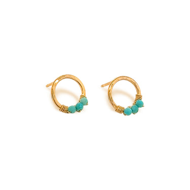 Gold hoop earrings with turquoise beads on a white background